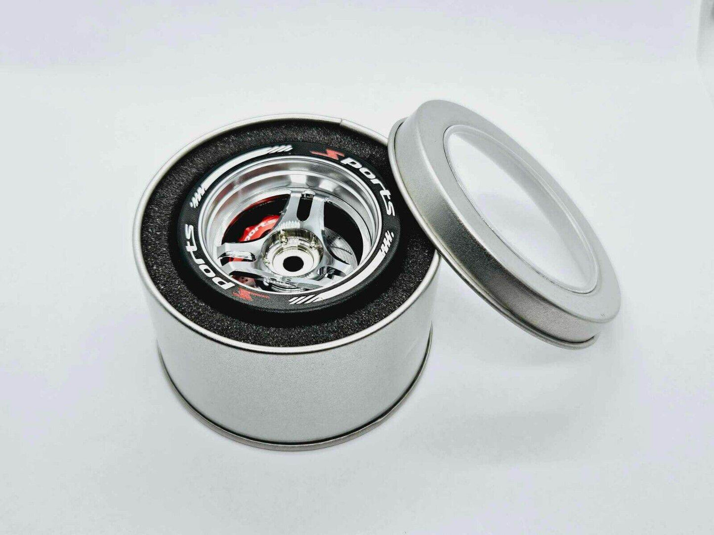 Close-up of the colourful RC transmitter steering wheel showing compatibility with major brands like SANWA, FUTABA, and FLYSKY