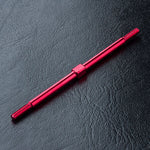 Close-up of MST Aluminium Turnbuckle 3x76mm in Red/Black #810016 for RC car suspension Red