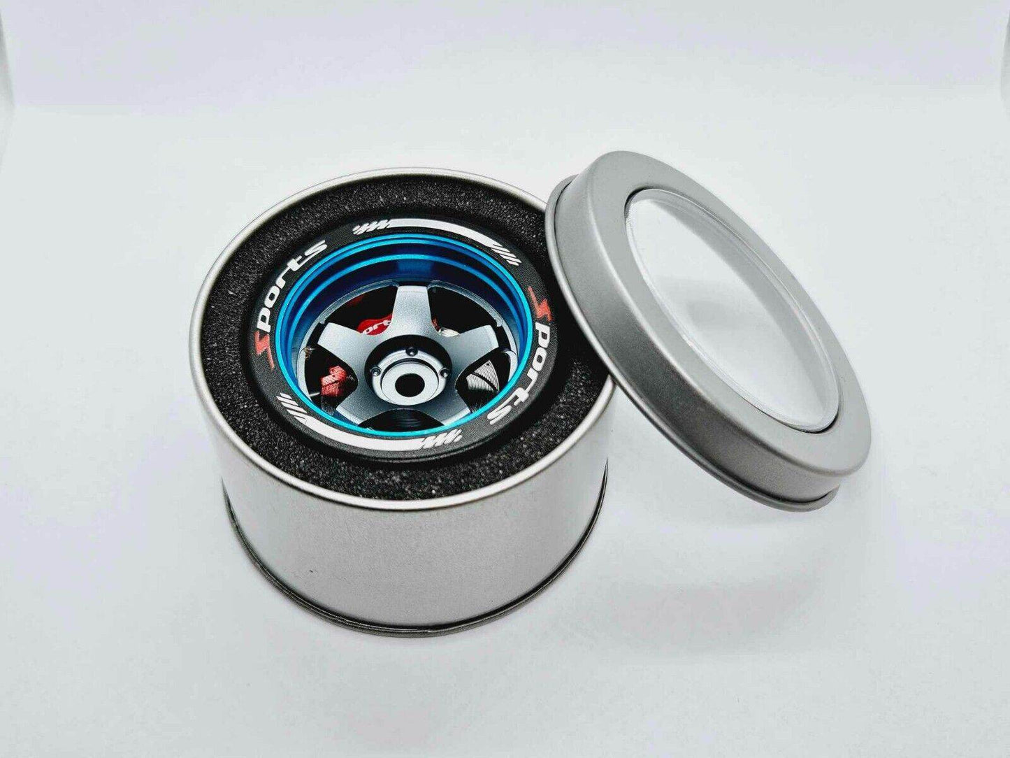 Close-up of the colorful RC transmitter steering wheel showing compatibility with major brands like SANWA, FUTABA, and FLYSKY