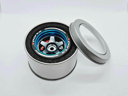 Close-up of the colorful RC transmitter steering wheel showing compatibility with major brands like SANWA, FUTABA, and FLYSKY