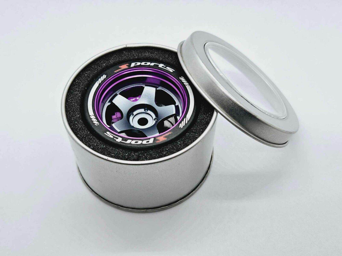 Close-up of the colorful RC transmitter steering wheel showing compatibility with major brands like SANWA, FUTABA, and FLYSKY