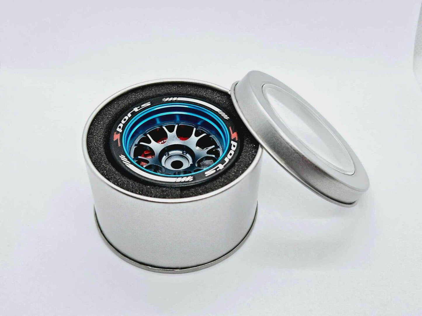 Close-up of the colourful RC transmitter steering wheel showing compatibility with major brands like SANWA, FUTABA, and FLYSKY
