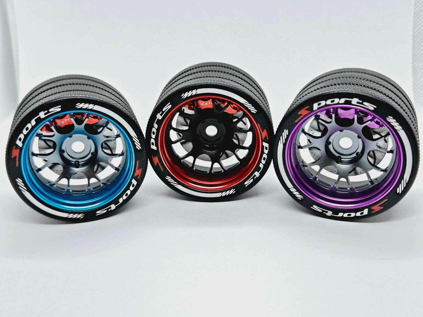 Close-up of the colourful RC transmitter steering wheel showing compatibility with major brands like SANWA, FUTABA, and FLYSKY