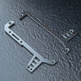 Close-up of MST FRX 2.5mm Carbon Front Bulkhead Deck Set, #210714