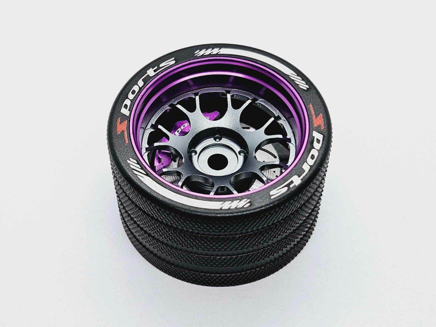 Close-up of the colourful RC transmitter steering wheel showing compatibility with major brands like SANWA, FUTABA, and FLYSKY
