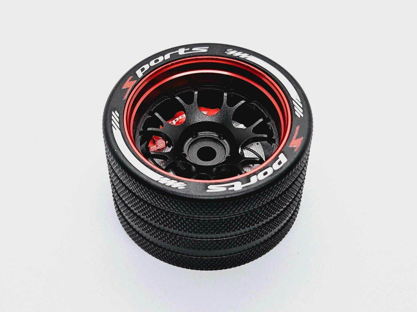 Close-up of the colourful RC transmitter steering wheel showing compatibility with major brands like SANWA, FUTABA, and FLYSKY
