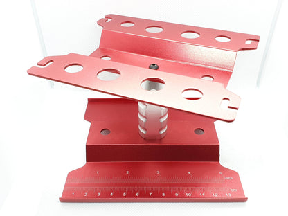 Close-up of the height-adjustable RC car stand, showcasing its sturdy construction and versatile use for 1/10 scale models - red
