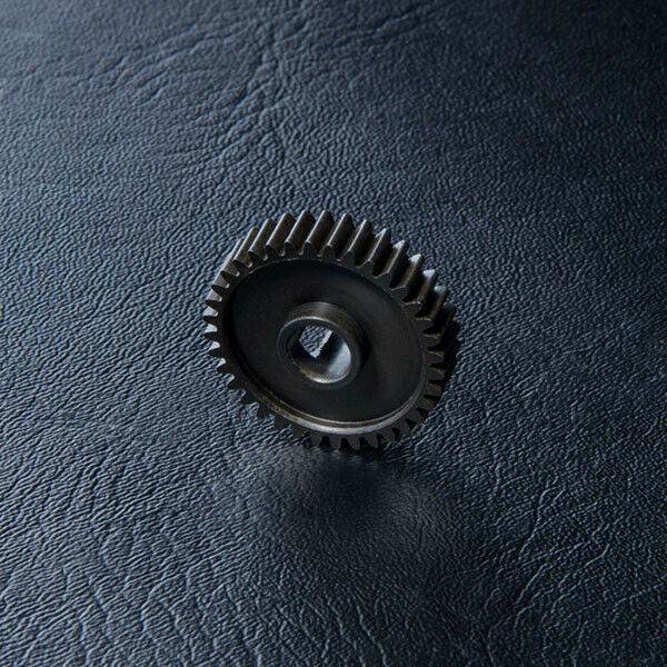 Close-up of MST FXX Transmission Plastic Gear C 36T #210350 for RC models 210350