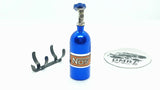 Close-up of aluminium 1/10 scale RC NOS bottle, designed as a balance weight for enhanced vehicle stability - blue
